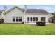 Backyard with an exterior patio, large grassy lawn, and mature landscaping at 1445 Ashley Gardens Blvd, Charleston, SC 29414