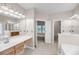 Large bathroom with double vanities, soaking tub, tile floors and access to bedroom and walk-in closet at 1445 Ashley Gardens Blvd, Charleston, SC 29414