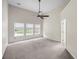 Expansive bedroom with three windows, a ceiling fan, and soft carpeting for ultimate comfort at 1445 Ashley Gardens Blvd, Charleston, SC 29414