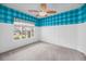 Cheerful bedroom with white paneled walls, blue checkered wallpaper, and natural light at 1445 Ashley Gardens Blvd, Charleston, SC 29414