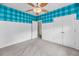 Bedroom featuring white paneled walls, blue checkered wallpaper, double door closet and a ceiling fan at 1445 Ashley Gardens Blvd, Charleston, SC 29414