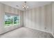 Serene bedroom with striped wallpaper, a large window, and neutral carpeting for a calming atmosphere at 1445 Ashley Gardens Blvd, Charleston, SC 29414
