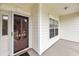 Inviting front door of home showing address and adjacent covered porch area with large window at 1445 Ashley Gardens Blvd, Charleston, SC 29414