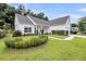 Attractive one-story home with neat landscaping, green lawn, and charming walkway to front door at 1445 Ashley Gardens Blvd, Charleston, SC 29414