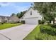 Inviting one-story home featuring manicured lawn, mature trees, and a two-car garage at 1445 Ashley Gardens Blvd, Charleston, SC 29414