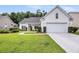 Charming one-story home featuring manicured lawn, tidy landscaping, and a two-car garage at 1445 Ashley Gardens Blvd, Charleston, SC 29414