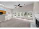 Bright living room featuring plush carpeting, a fireplace, and large windows overlooking the backyard at 1445 Ashley Gardens Blvd, Charleston, SC 29414
