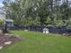 Spacious backyard with lush green grass, mature trees, and a charming playhouse at 1489 Red Tide Rd, Mount Pleasant, SC 29466