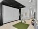 Home theater and play area in a basement with a large screen, seating, and recreational equipment at 1489 Red Tide Rd, Mount Pleasant, SC 29466