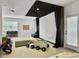 Basement movie theater with projector screen, casual seating, and a window for natural light; perfect for entertaining at 1489 Red Tide Rd, Mount Pleasant, SC 29466