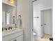 Bright bathroom featuring a white vanity with modern fixtures and a framed mirror, enhancing its simple, elegant design at 1489 Red Tide Rd, Mount Pleasant, SC 29466