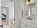 Bright bathroom featuring a white vanity with modern fixtures and a framed mirror, enhancing its simple, elegant design at 1489 Red Tide Rd, Mount Pleasant, SC 29466