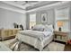 A serene bedroom featuring tray ceilings, neutral tones, and stylish furnishings at 1489 Red Tide Rd, Mount Pleasant, SC 29466