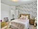 Bedroom with bed decorated with pink accents, complemented by a patterned accent wall and natural light at 1489 Red Tide Rd, Mount Pleasant, SC 29466