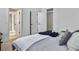 Bedroom with a bed dressed in cozy linens, and a view of hallway entrances with a wardrobe visible to the right at 1489 Red Tide Rd, Mount Pleasant, SC 29466