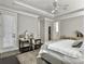 A bedroom boasts a workspace, tray ceilings, and access to a bathroom at 1489 Red Tide Rd, Mount Pleasant, SC 29466