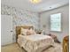 Bedroom with bed decorated with pink accents, complemented by a patterned accent wall and natural light at 1489 Red Tide Rd, Mount Pleasant, SC 29466