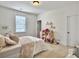 Bedroom featuring a bed with a pink patterned comforter, a whimsical wardrobe and playful decorations in the room at 1489 Red Tide Rd, Mount Pleasant, SC 29466