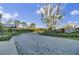 A landscaped community entrance with a winding road, lush trees, and attractive architecture at 1489 Red Tide Rd, Mount Pleasant, SC 29466