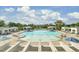 A spacious community pool with ample seating, cabanas, and landscaped areas on a sunny day at 1489 Red Tide Rd, Mount Pleasant, SC 29466