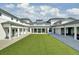 Picturesque courtyard featuring expansive green space, white pillars, and a bright open design at 1489 Red Tide Rd, Mount Pleasant, SC 29466