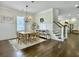 Elegant dining room with a stylish chandelier, wainscoting, and hardwood floors at 1489 Red Tide Rd, Mount Pleasant, SC 29466