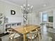 Elegant dining room featuring a modern chandelier and hardwood floors, adjacent to the staircase at 1489 Red Tide Rd, Mount Pleasant, SC 29466