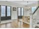 Dining room featuring wainscoting, dark wood floors, designer chandelier, and a wooden dining table at 1489 Red Tide Rd, Mount Pleasant, SC 29466