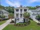 Charming two-story home with double front porches, landscaped yard, and palm trees at 1489 Red Tide Rd, Mount Pleasant, SC 29466