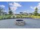 Community fire pit at the neighborhood pond, complete with patio and lush landscaping at 1489 Red Tide Rd, Mount Pleasant, SC 29466