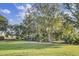 Expansive green space surrounded by mature trees, offering a serene environment for residents at 1489 Red Tide Rd, Mount Pleasant, SC 29466