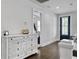 Bright hallway features a white dresser, wood floors, and a rear door with glass panels at 1489 Red Tide Rd, Mount Pleasant, SC 29466