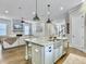 Kitchen with a large island, stainless steel sink, hardwood flooring, and open concept layout at 1489 Red Tide Rd, Mount Pleasant, SC 29466