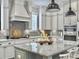 Well-appointed kitchen features stainless appliances, gray backsplash, and granite island at 1489 Red Tide Rd, Mount Pleasant, SC 29466