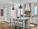 Charming kitchen features a large island with seating and modern light fixtures at 1489 Red Tide Rd, Mount Pleasant, SC 29466