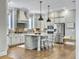 Spacious kitchen featuring stainless steel appliances, island with seating, and stylish pendant lighting at 1489 Red Tide Rd, Mount Pleasant, SC 29466