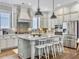 Spacious kitchen featuring stainless steel appliances, island with seating, and stylish pendant lighting at 1489 Red Tide Rd, Mount Pleasant, SC 29466