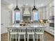 Bright kitchen with a large island, white cabinetry, and modern pendant lighting at 1489 Red Tide Rd, Mount Pleasant, SC 29466