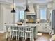Kitchen features an island with seating, pendant lights, granite countertop, and stainless steel appliances at 1489 Red Tide Rd, Mount Pleasant, SC 29466