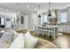 Bright, open kitchen island with seating, pendant lights, and stainless steel appliances at 1489 Red Tide Rd, Mount Pleasant, SC 29466