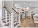 View of the kitchen and stairs with wooden steps and white risers and railings at 1489 Red Tide Rd, Mount Pleasant, SC 29466