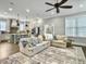 Open floor plan featuring a living room with ceiling fan and view of kitchen with island seating at 1489 Red Tide Rd, Mount Pleasant, SC 29466