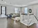 Spacious living room features wood floors, a comfortable grey couch, and ample natural light at 1489 Red Tide Rd, Mount Pleasant, SC 29466