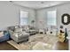 Open living space features a grey sectional, toys, and a patterned area rug at 1489 Red Tide Rd, Mount Pleasant, SC 29466