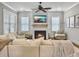 Living room with fireplace, ceiling fan, hardwood floors, and cozy decor at 1489 Red Tide Rd, Mount Pleasant, SC 29466