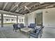 A covered outdoor lounge area with comfortable seating and attractive landscaping at 1489 Red Tide Rd, Mount Pleasant, SC 29466