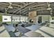A covered outdoor lounge area with a fireplace, comfortable seating, picnic tables, and attractive landscaping at 1489 Red Tide Rd, Mount Pleasant, SC 29466