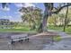 Scenic community park with a bench under mature trees and a walking path, perfect for outdoor relaxation at 1489 Red Tide Rd, Mount Pleasant, SC 29466