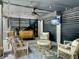 A stylish outdoor patio with wicker furniture, a grill, and a TV for entertaining at 1489 Red Tide Rd, Mount Pleasant, SC 29466
