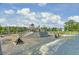 A play area with wood-themed structure, wooden stairs, and slides, surrounded by lush trees and gravel groundcover at 1489 Red Tide Rd, Mount Pleasant, SC 29466